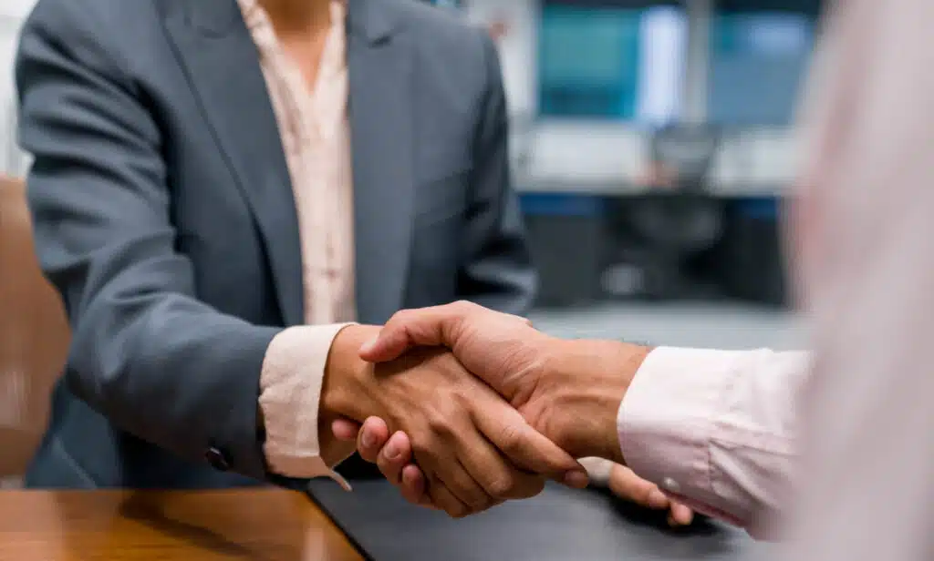 Attorney offering a job to a candidate in a law office setting