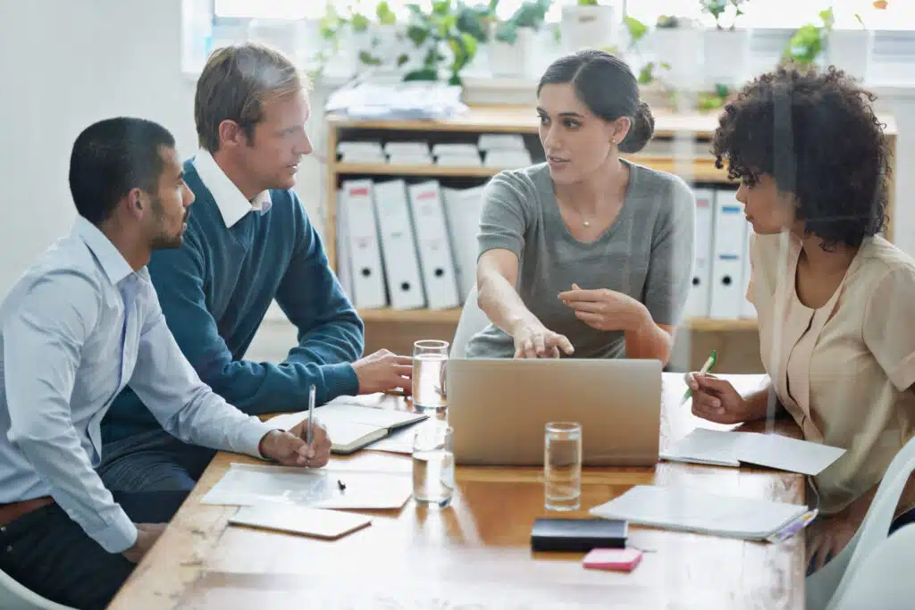 A law firm leadership team undergoes leadership training in a casual office environment